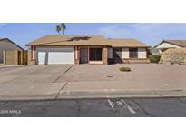 Charming single-story home featuring a two-car garage and low-maintenance gravel landscaping at 840 E Hackamore St, Mesa, AZ 85203