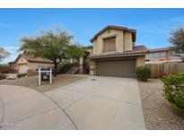 Charming two-story home boasts a desert landscape, a two-car garage, and a tile roof at 10212 E Betony Dr, Scottsdale, AZ 85255