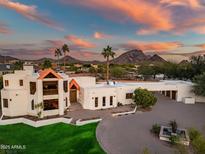 Stunning aerial view of a modern home showcasing its unique architecture and desert landscape at sunset at 10301 N 128Th St, Scottsdale, AZ 85259