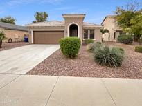 Charming single story home with desert landscaping, a two car garage, and a welcoming front entryway at 12163 W Chase Ln, Avondale, AZ 85323