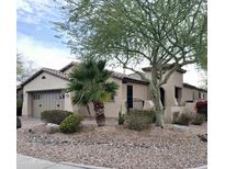 Charming single-story home with well-maintained desert landscaping and a two-car garage at 12733 W Mine Trl, Peoria, AZ 85383