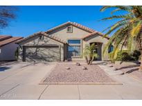 Charming single-story home with a two-car garage, desert landscaping, and tile roof at 1896 S Porter St, Gilbert, AZ 85295