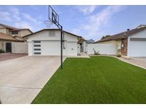 Charming home featuring a pristine front yard, well-kept lawn, and a basketball hoop for added curb appeal at 4233 E Covina St, Mesa, AZ 85205