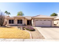 Charming single-story home featuring a two-car garage, neutral stucco exterior, and desert landscaping at 6401 W Irma Ln, Glendale, AZ 85308