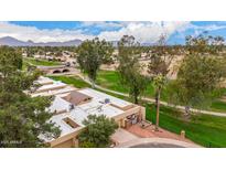 Stunning aerial view of the property showcasing roof, landscaping, golf course, and surrounding neighborhood at 9090 N 86Th Pl, Scottsdale, AZ 85258