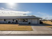 Charming single-story home with light brick, desert landscaping, and an attached two-car garage at 10019 W Shasta Dr, Sun City, AZ 85351