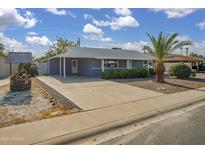 Charming single-story home features a spacious driveway, xeriscape landscaping, and inviting curb appeal at 12408 N Cherry Hills W Dr, Sun City, AZ 85351