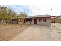 Charming single-story home with desert landscaping, covered entryway, and red accents at 13439 N 16Th Ave, Phoenix, AZ 85029