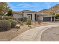 Beautiful single-story home featuring well-maintained desert landscaping and an attached two-car garage at 15229 E Marigold Ct, Fountain Hills, AZ 85268