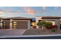 Beautiful single-story home featuring a two-car garage and desert landscaping at 18024 E Wolf Tree Ln, Rio Verde, AZ 85263