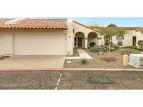 Charming home featuring an attached garage, arched entryway, and desert landscaping at 1930 S Westwood Dr # 29, Mesa, AZ 85210