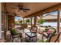 Inviting covered patio with comfortable seating and ceiling fans for relaxing outdoors at 1973 E Buena Vista Dr, Chandler, AZ 85249