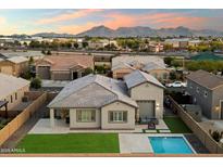 Stunning aerial view of home featuring a backyard pool and lush green lawn with mountain views at 20954 E Camacho Ct, Queen Creek, AZ 85142