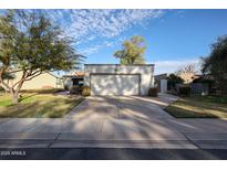 Single story house with an attached garage and mature landscaping, set against a blue sky at 592 Leisure World --, Mesa, AZ 85206