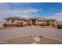 Single story stucco home featuring circular driveway and tiled roof at 6786 W Appaloosa Trl, Coolidge, AZ 85128