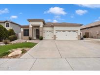 Charming single-story home with a well-manicured lawn and a three-car garage at 6890 W Remuda Dr, Peoria, AZ 85383