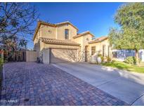 Charming two-story home with a spacious driveway and manicured front yard, showcasing curb appeal at 7010 S San Jacinto Ct, Gilbert, AZ 85298