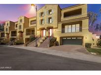 Attractive townhome exterior features stairs to front door, a covered patio and an attached two-car garage at 7130 W Linda Ln, Chandler, AZ 85226