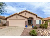 Charming single-story home featuring a two-car garage and low maintenance desert landscaping at 8204 W Tonto Ln, Peoria, AZ 85382