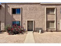 Inviting townhome featuring a stucco facade, complemented by mature landscaping and a cozy front entry at 8410 N 32Nd Ave, Phoenix, AZ 85051