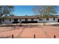 Charming single-story home with a red concrete drive and a well-maintained yard at 1216 N 66Th Pl, Mesa, AZ 85205