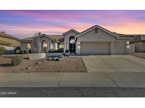 Charming single-story home with a landscaped front yard and a spacious two-car garage at 1635 E Silverwood Dr, Phoenix, AZ 85048