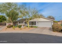 Charming single-story home with desert landscaping, mature trees, and a two-car garage at 204 E Del Rio Dr, Tempe, AZ 85282