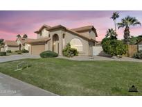 Charming home featuring a well-manicured lawn, desert landscaping, and a two-car garage at 2340 W Myrtle Dr, Chandler, AZ 85248