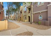 Condos showcase neutral facades, walkways, and manicured landscaping, creating an inviting community at 240 W Juniper Ave # 1010, Gilbert, AZ 85233