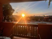 Balcony view of a community pool with lounge chairs under a vibrant sunset sky in a relaxing atmosphere at 3031 N Civic Center Plz # 261, Scottsdale, AZ 85251