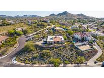 Stunning aerial view of a desert home with a meticulously landscaped yard and mountain backdrop at 3101 E Acoma Dr, Phoenix, AZ 85032