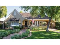 Charming vintage home with manicured front yard and brick pathway leading to the welcoming front entrance at 34 W Vernon Ave, Phoenix, AZ 85003