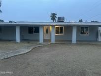 Charming single-story home featuring a covered front porch, light-colored facade, and desert landscaping at 3425 N 8Th Ave, Phoenix, AZ 85013