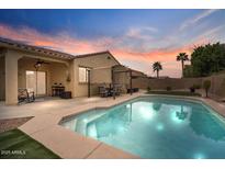 Sparkling pool with covered patio, landscaping, and perimeter fencing at 3716 E Andre Ave, Gilbert, AZ 85298