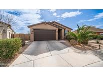Charming single-Gathering home featuring a well-maintained front yard and attached two-car garage at 40433 W Hensley Way, Maricopa, AZ 85138