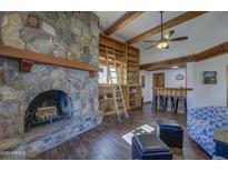 Comfortable living room featuring a stone fireplace, bookshelves, and cozy seating at 40445 N 32Nd St, Cave Creek, AZ 85331