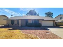 Charming single-story brick home with a well-maintained lawn, offering a classic and inviting curb appeal at 4547 W Villa Theresa Dr, Glendale, AZ 85308