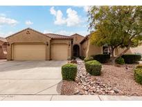 Charming single-story home with a xeriscaped yard, mature tree, and a two-car garage at 6473 W Victory Way, Florence, AZ 85132