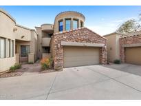 Beautiful two story home featuring a stone garage and a private drive at 7445 E Eagle Crest Dr # 1094, Mesa, AZ 85207