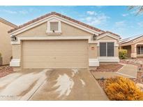 Charming single-story home featuring a two-car garage, neutral stucco, and red tile roofing at 11330 W Eden Mckenzie Dr, Surprise, AZ 85378