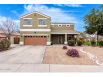 Inviting two-story home featuring low maintenance landscaping and a covered front porch at 12162 W Dreyfus Dr, El Mirage, AZ 85335