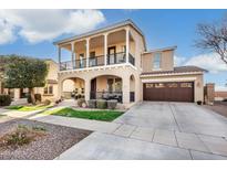 Inviting two-story home with a charming front porch and second story balcony at 13432 N 154Th Ln, Surprise, AZ 85379