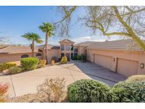 Stunning home featuring desert landscaping, barrel tile roof and circular driveway leading to a three car garage at 15241 E Pageland Cir, Fountain Hills, AZ 85268