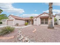 Charming single-story home with a desert landscape, tile roof and a two car garage at 15525 W Clear Canyon Dr, Surprise, AZ 85374