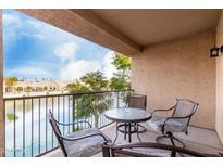 Inviting patio featuring a table with chairs and views of the water at 16013 S Desert Foothills Pkwy # 2082, Phoenix, AZ 85048