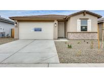 Charming single-Gathering home featuring a two-car garage and neutral stucco exterior with stone accents at 16036 W Desert Hollow Dr, Surprise, AZ 85387