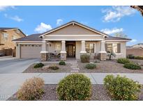 Charming single-story home featuring a well-manicured front yard, covered porch, and attached two-car garage at 19025 E Raven Dr, Queen Creek, AZ 85142