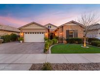 Charming single-story home with a manicured lawn, brick driveway, and attached two-car garage at 20551 E Mayberry Rd, Queen Creek, AZ 85142