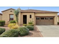 Charming single-story home with a two-car garage, desert landscaping, and a tile roof at 29588 N 129Th Dr, Peoria, AZ 85383