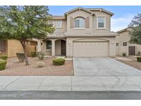 Two-story home featuring a two car garage, neutral colored stucco exterior, and a manicured front yard at 3263 S Miller Dr, Chandler, AZ 85286